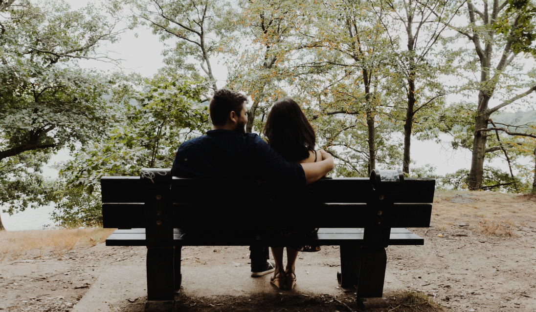 2 partners in a park sitting on a bench